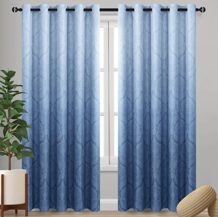 Indoor privacy curtains in light blue patterned fabric with grommet top for window privacy, room darkening, and home decor