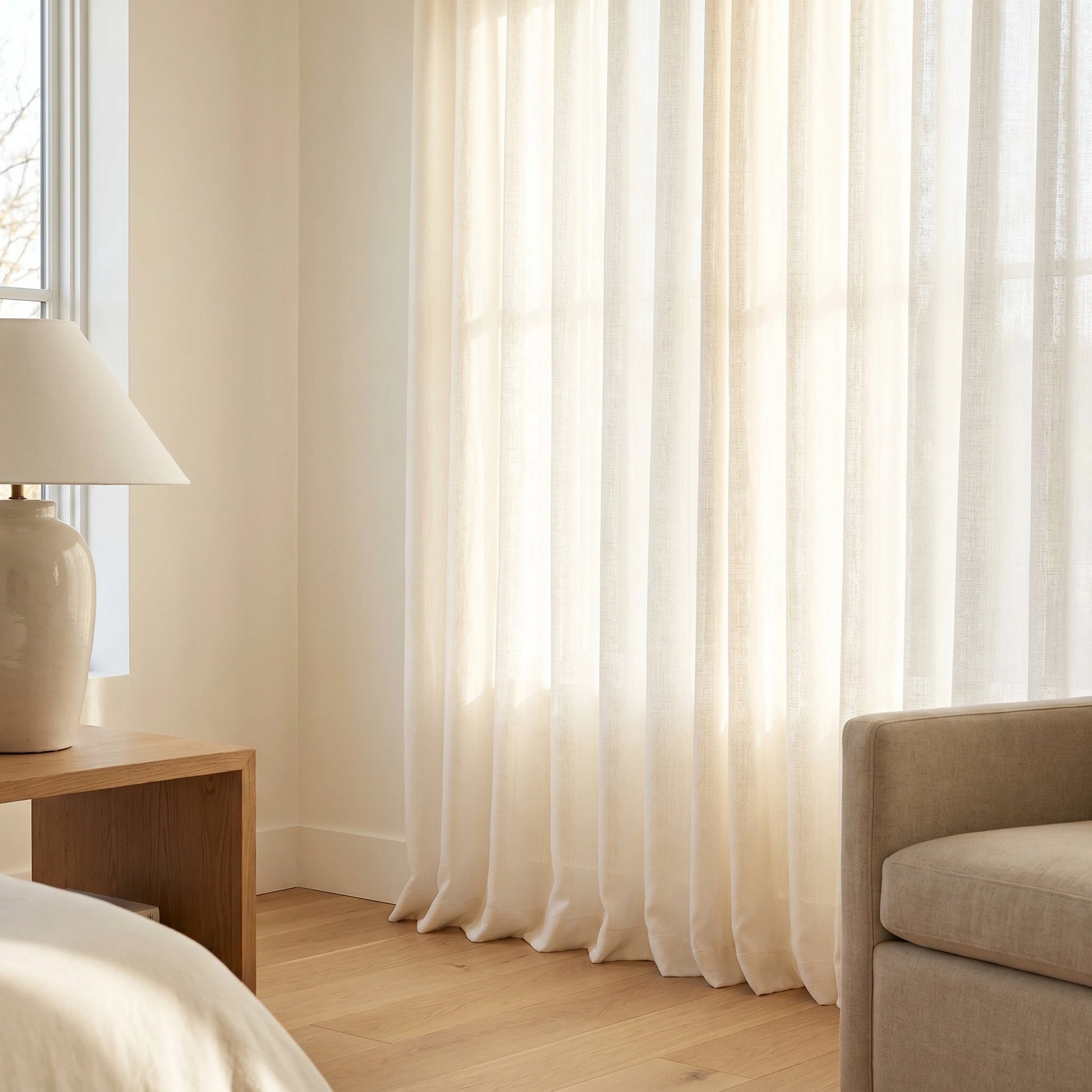 Light ivory Calliope Cream Linen Voile Curtain by DWCN Official hanging on a window, soft and airy fabric for elegant home decor.