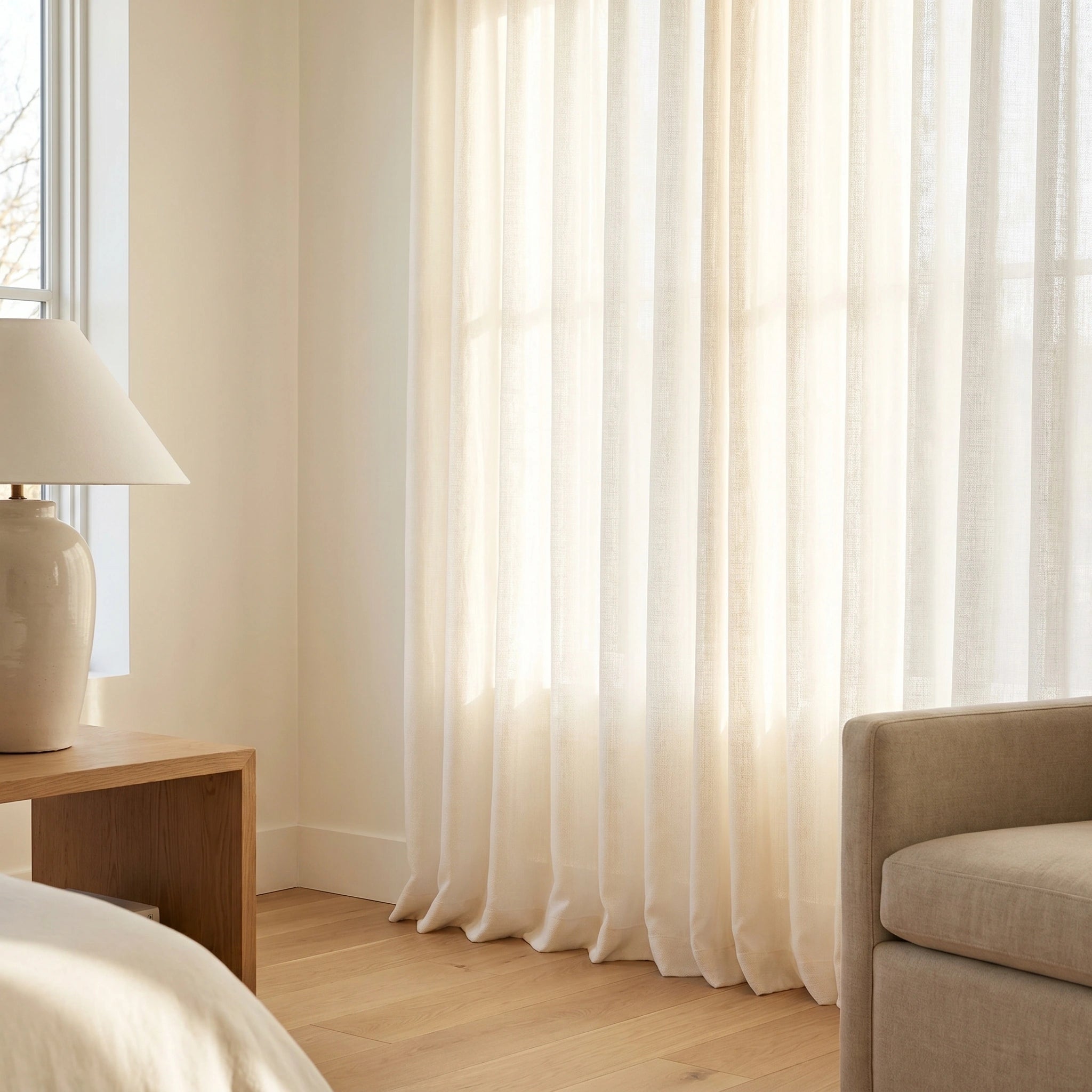 Light ivory Calliope Cream Linen Voile Curtain by DWCN Official hanging on a window, soft and airy fabric for elegant home decor.