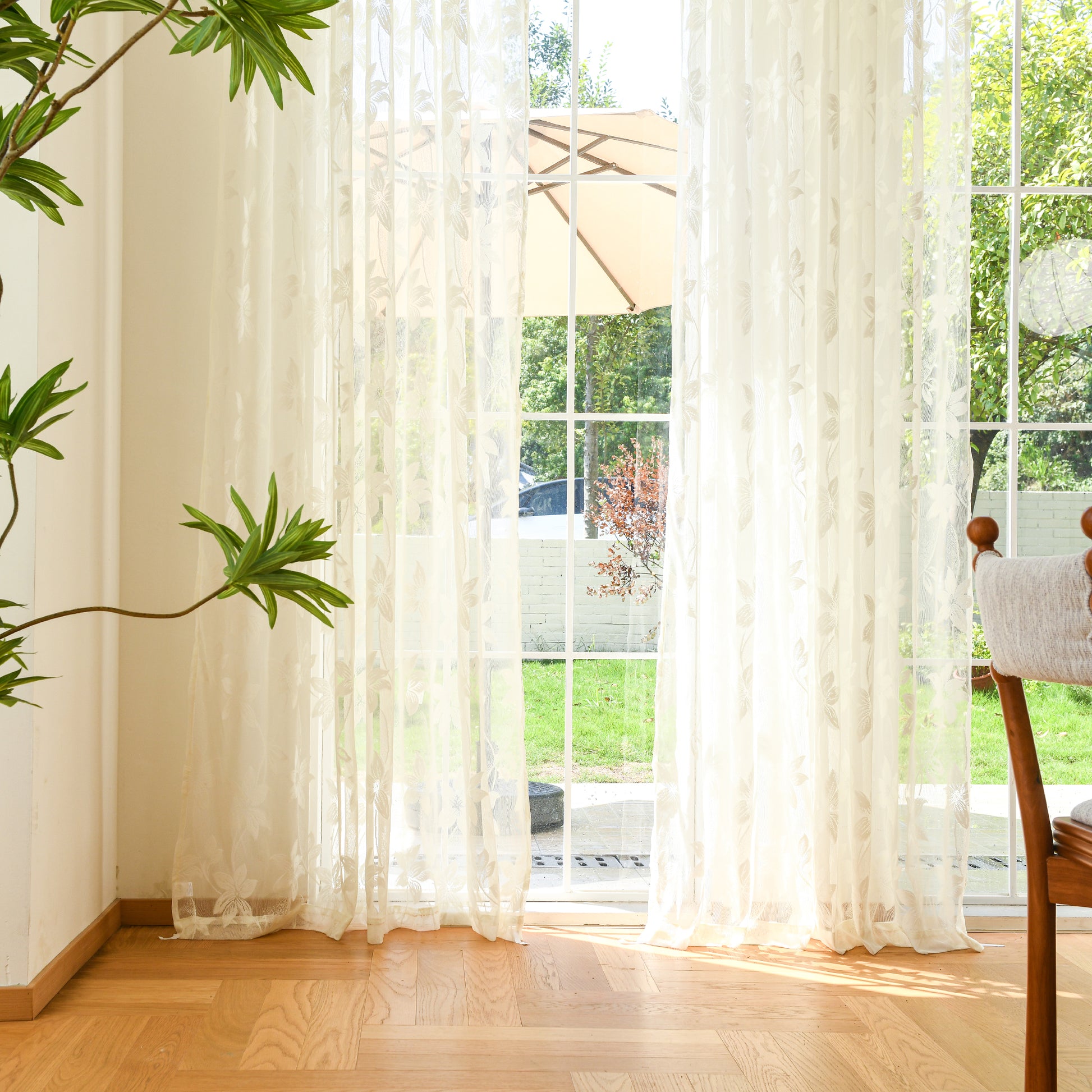 Semi-sheer lace curtains creating soft, elegant atmosphere