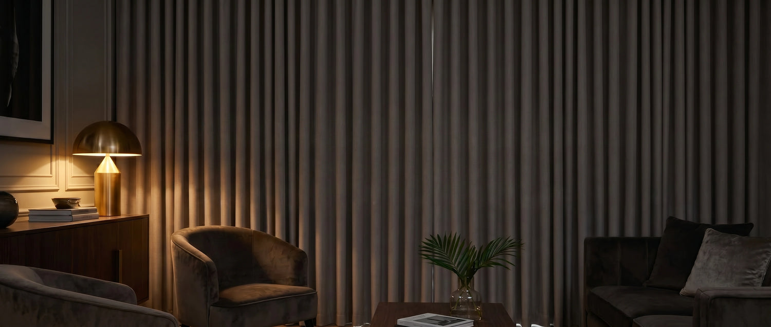 Custom living room curtains with dark gray pleated fabric, styled for floor to ceiling windows, evening privacy, and a luxury modern home look.