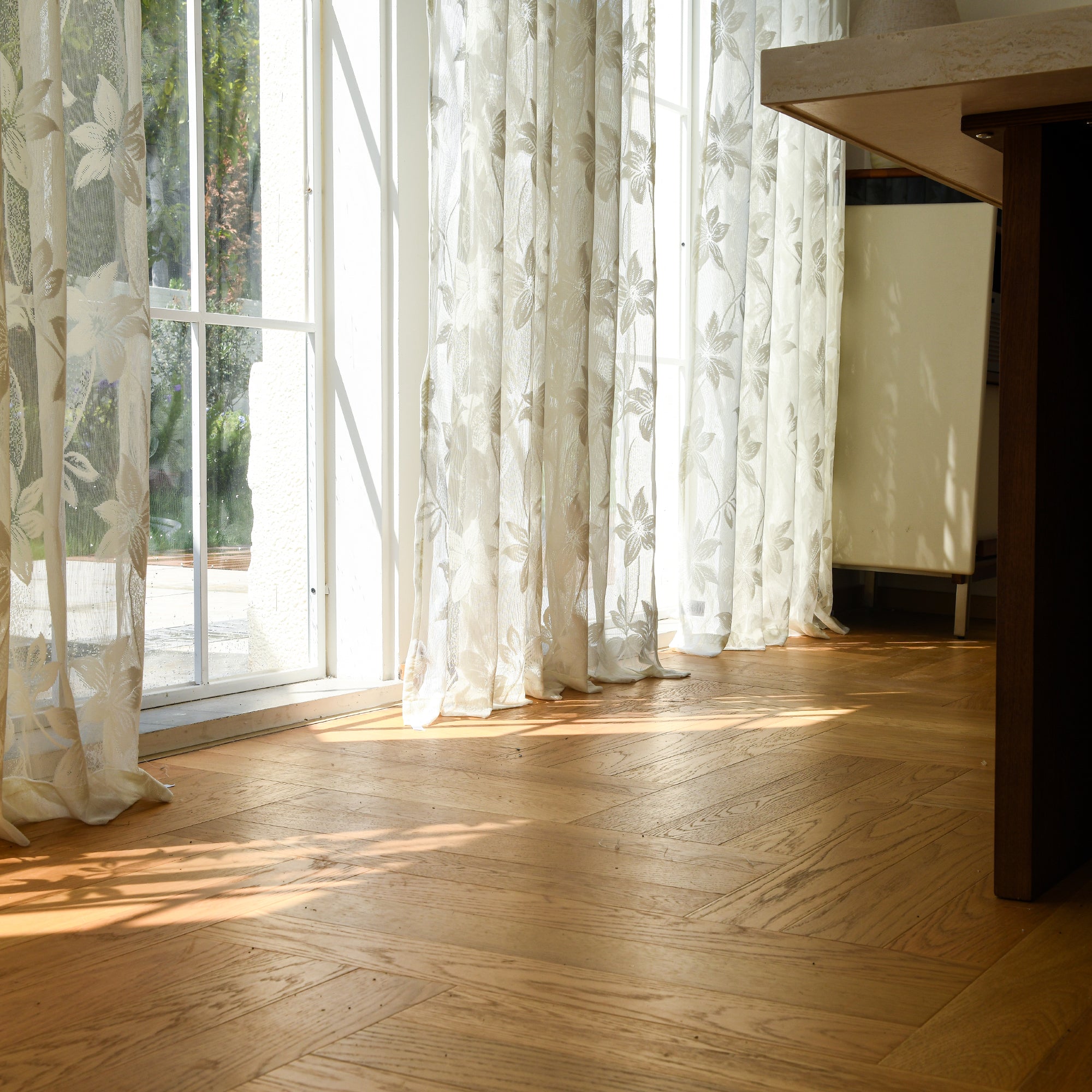 Semi-sheer lace curtains creating soft, elegant atmosphere