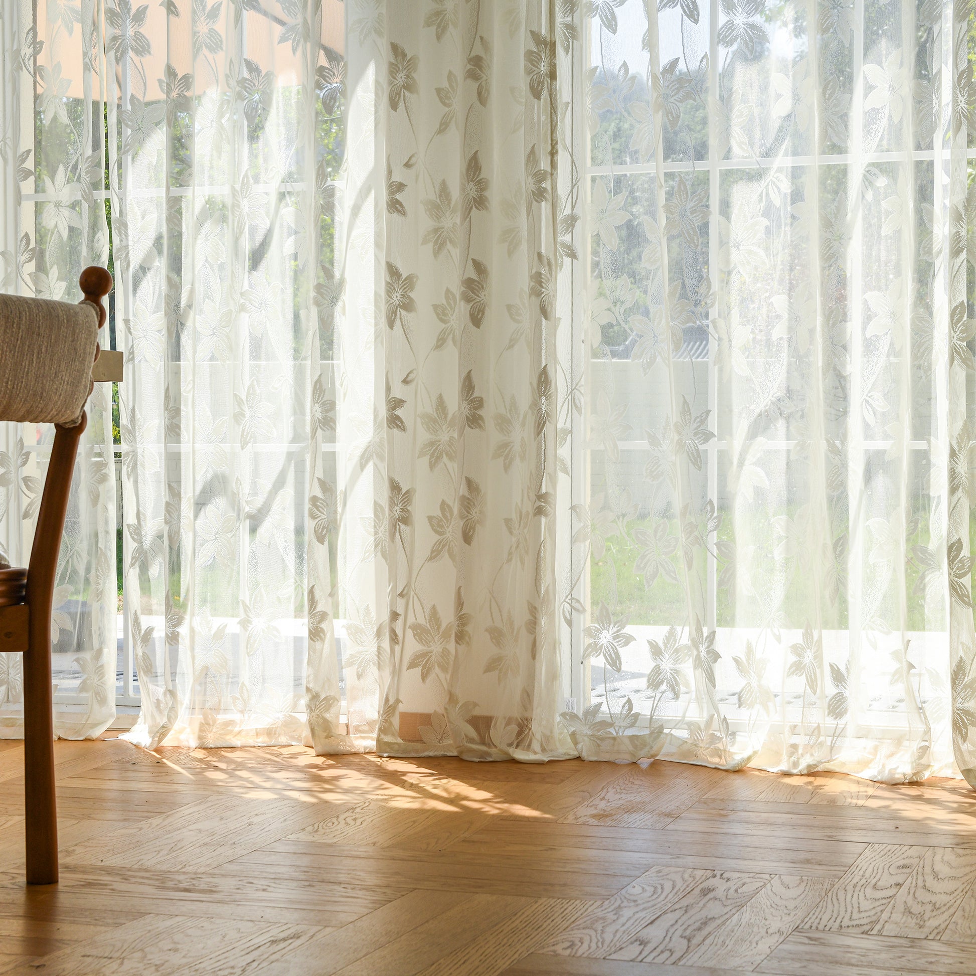 Semi-sheer lace curtains creating soft, elegant atmosphere