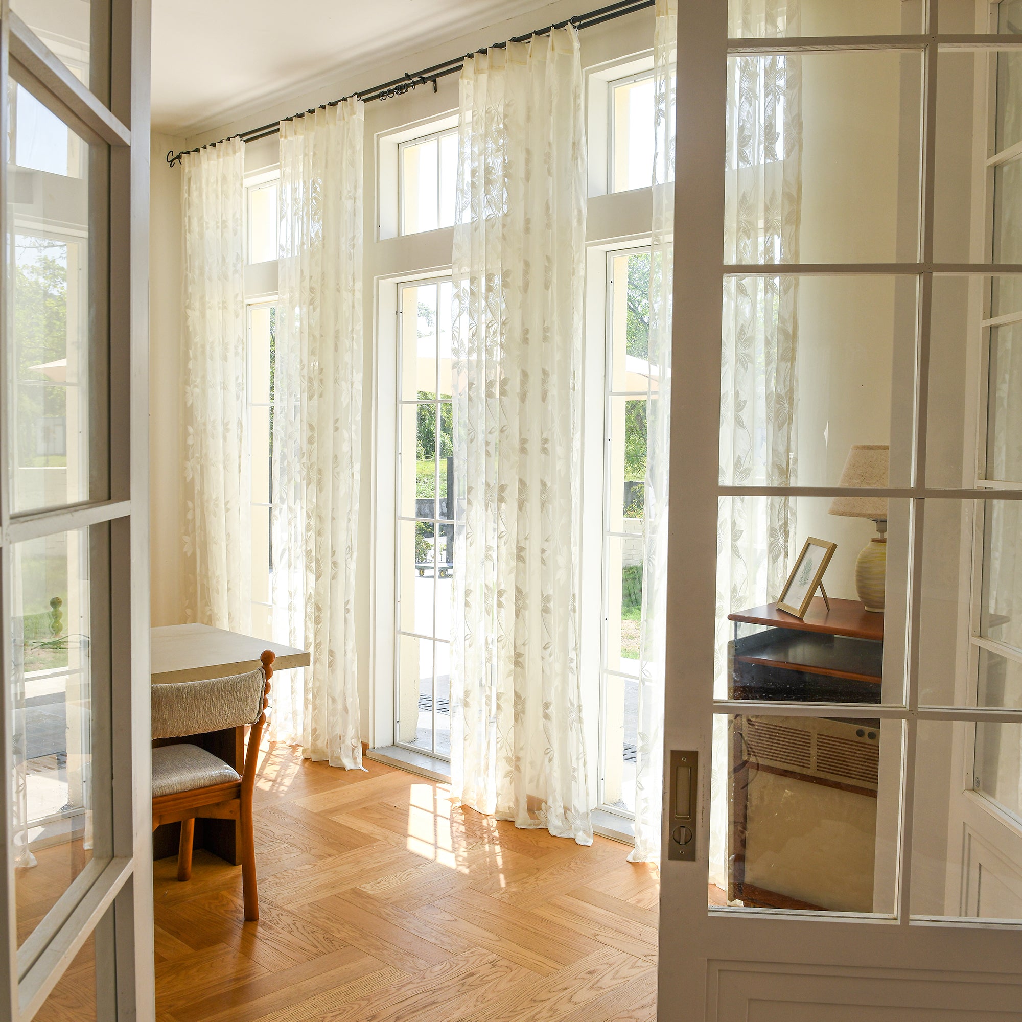 Semi-sheer lace curtains creating soft, elegant atmosphere