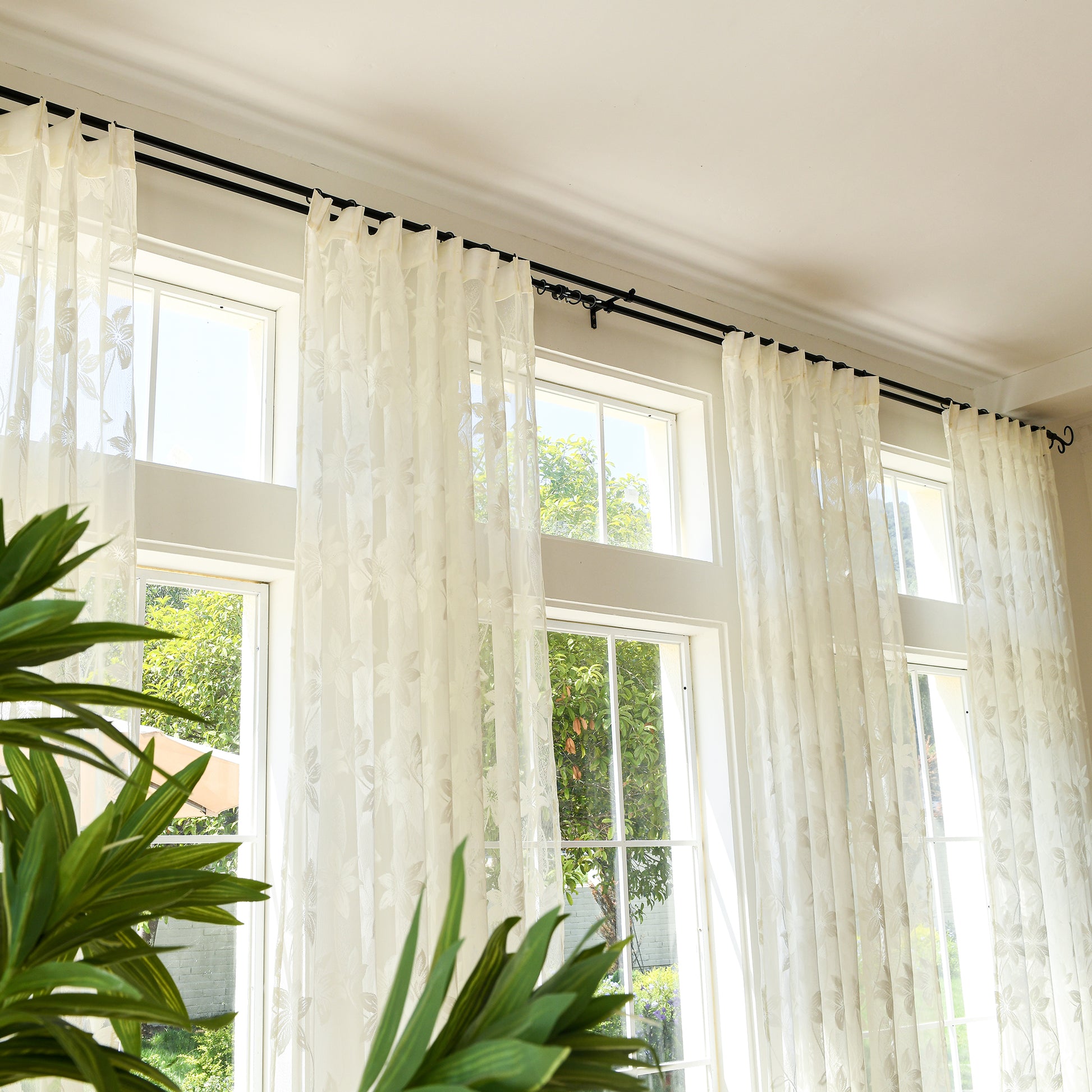 Semi-sheer lace curtains creating soft, elegant atmosphere