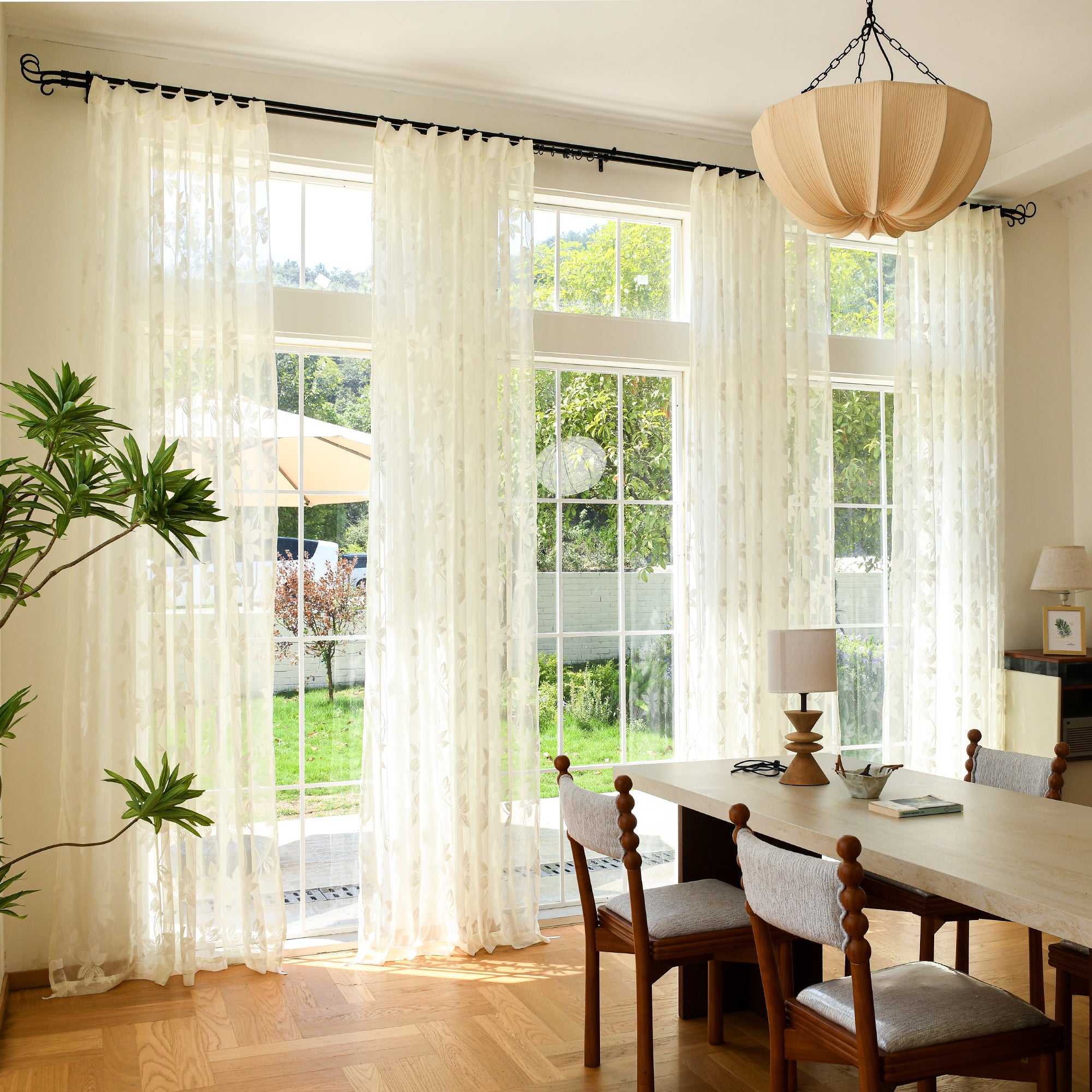 Custom voile curtains with delicate lace texture in window setting