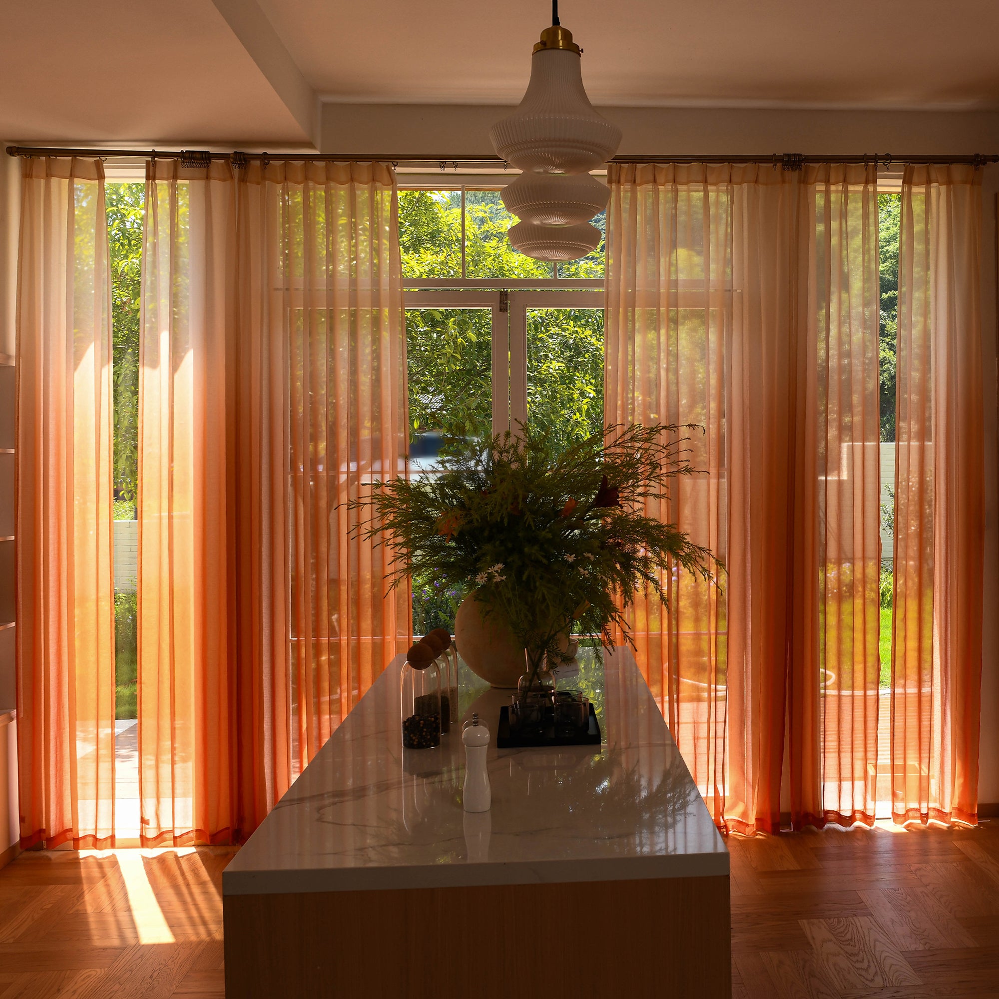 Custom ombre sheer curtains filtering daylight in minimalist home setting
