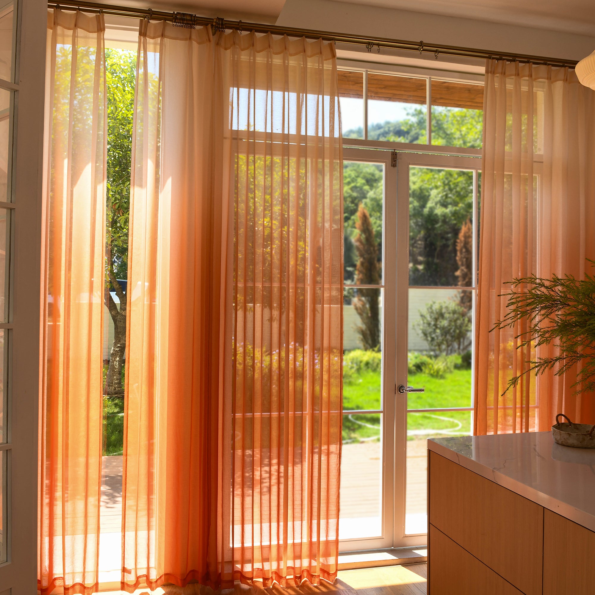 Custom ombre sheer curtains filtering daylight in minimalist home setting