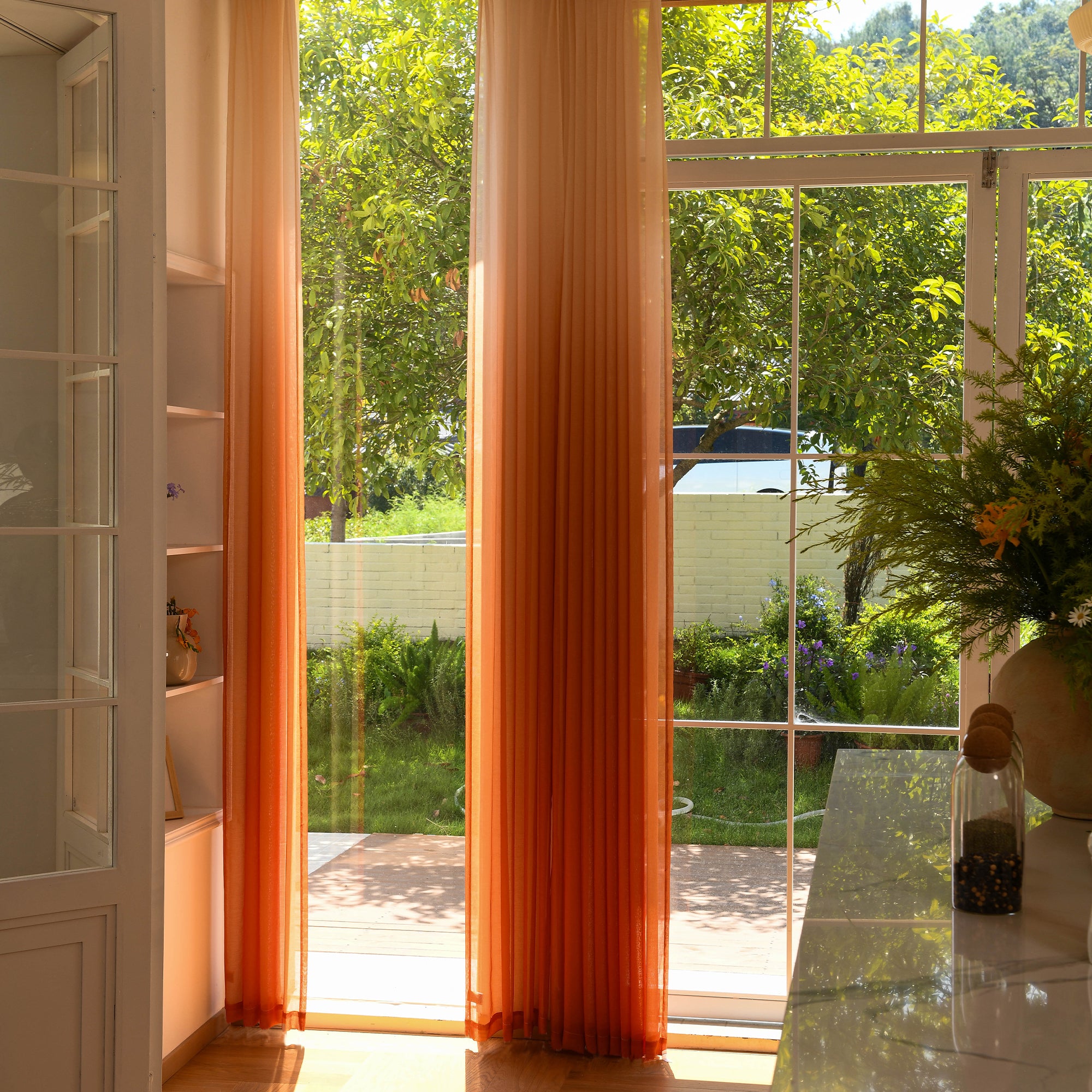 Vertical ombre sheer curtains adding height and softness to modern space