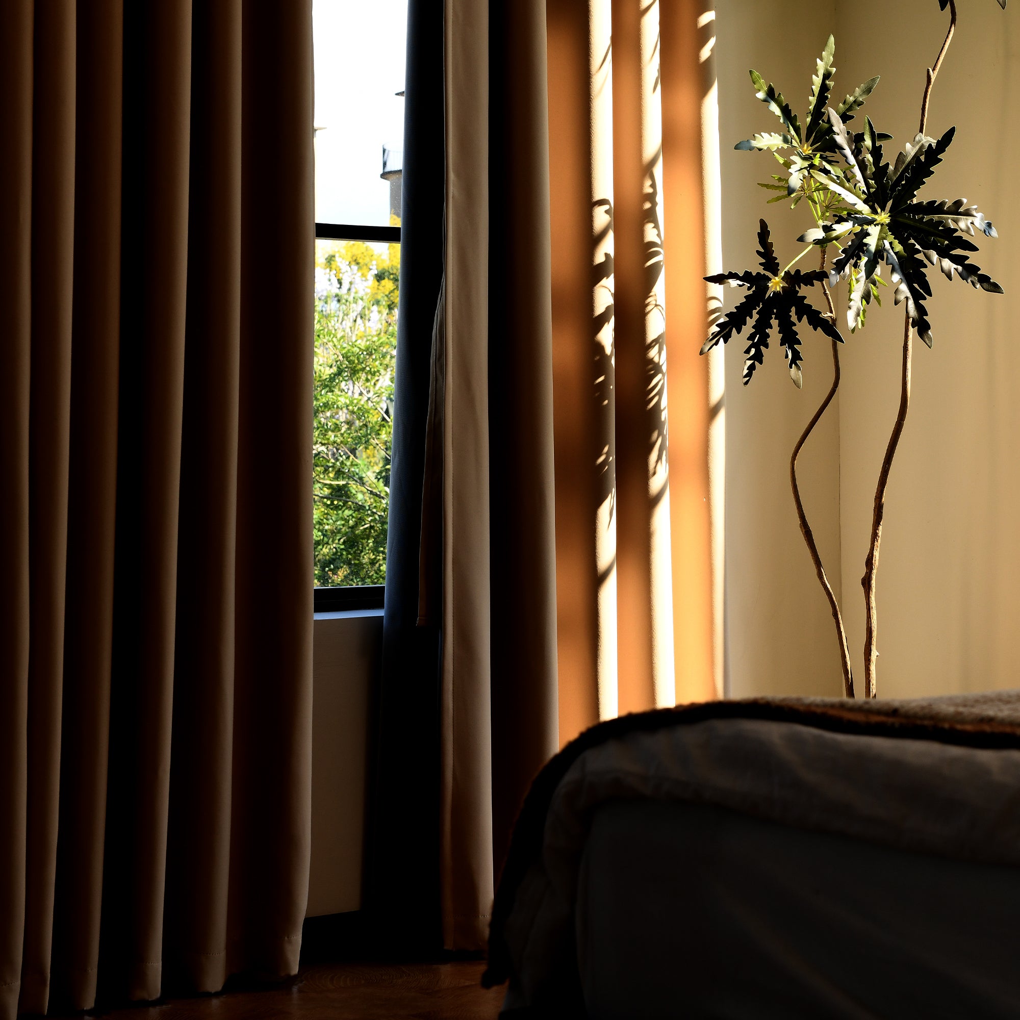 Silk-fiber blackout curtains blocking sunlight in bedroom