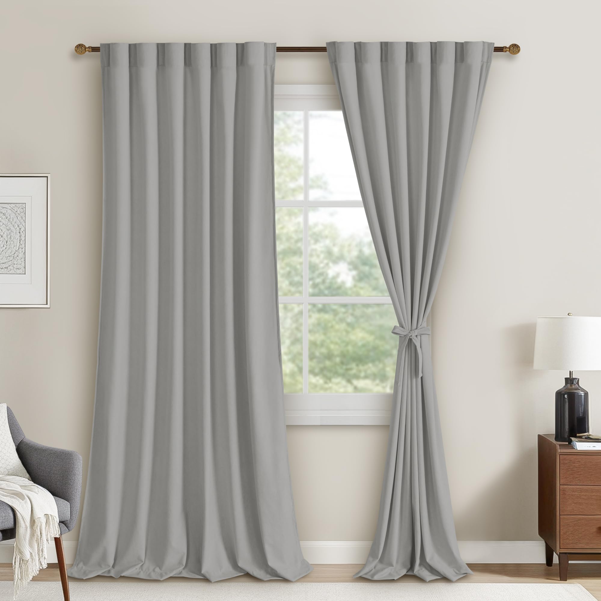 Two velvet curtain panels with rod pocket and back tab design, hanging side by side in a cozy living room.