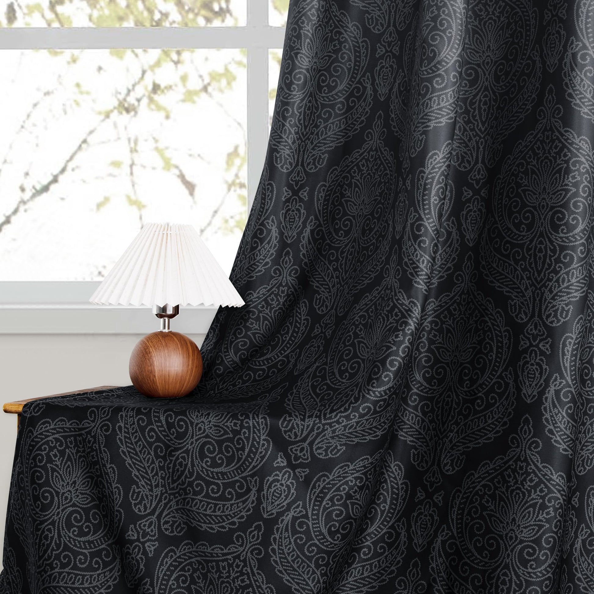 Set of two DWCN Official blackout curtains with ombre black design and tiebacks, hanging on a window with natural light.